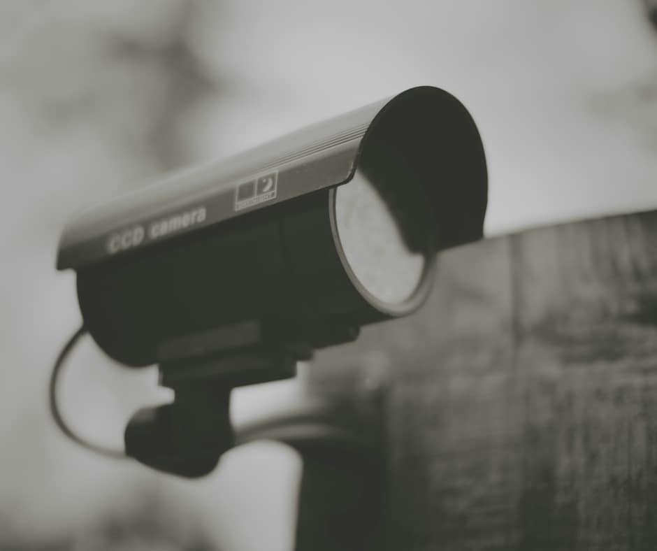 security camera adhered to the side of a building