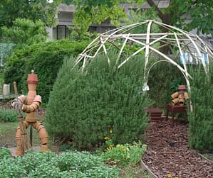 robots statues made out of pottery in a garden