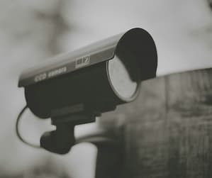 security camera adhered to the side of a building