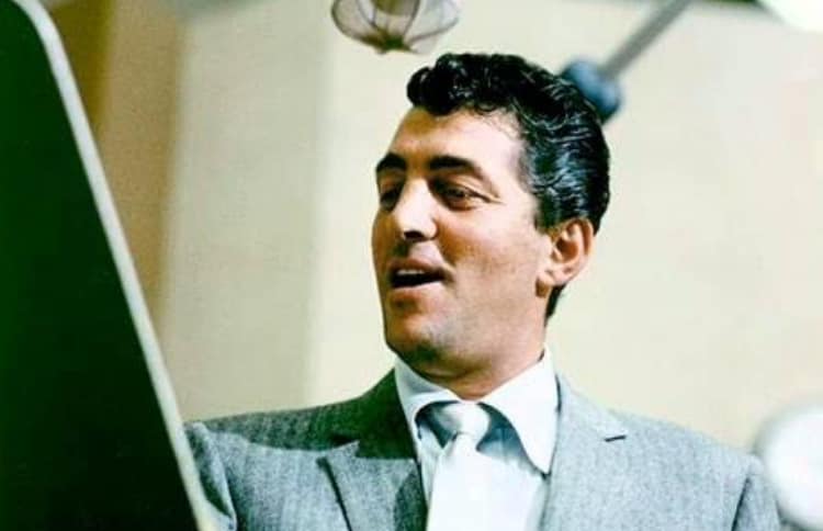 Dean Martin sings into a microphone