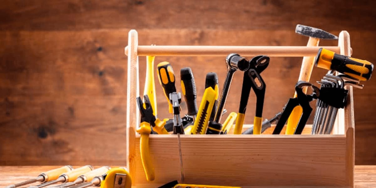toolbox filled with tools like a hammer