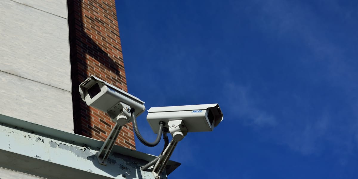 two security cameras on the roof of a building