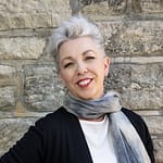 woman wearing a scarf smiles warmly