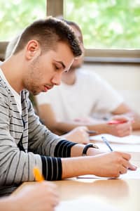 male college student sitting in a classroom