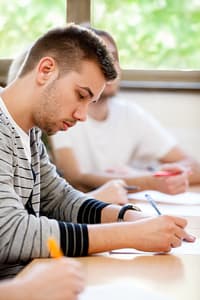 male college student sitting in a classroom