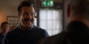 Ted Lasso has joy on his face after making a point about curiosity