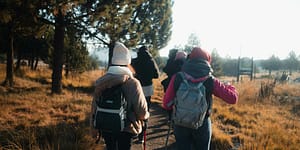 hikers head down a path together