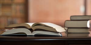Books sitting on a desk in a library