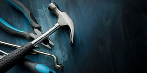 tools including a hammer with blue handles