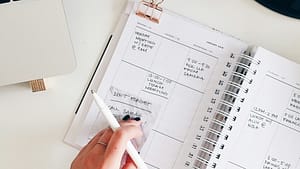 Planner sits on a desk with the at a week glance showing