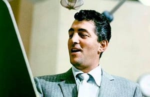 Dean Martin sings into a microphone