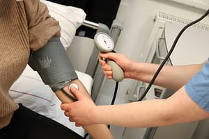 Nurse takes a patient's blood pressure