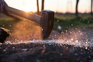 A sledgehammer breaks glass