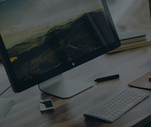 computer keyboard and monitor sitting on a desk