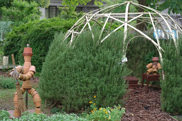robots statues made out of pottery in a garden