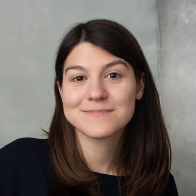 Maggie Appleton with dark brown hair smiles warmly
