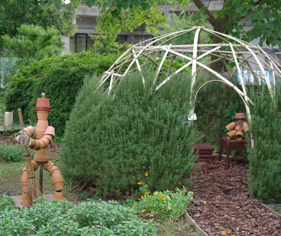 robots statues made out of pottery in a garden