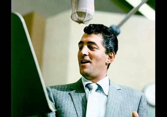 Dean Martin sings into a microphone